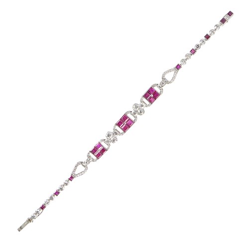 Art Deco ruby and diamond set loop bracelet by Cartier, Paris, centred by three square calibre ruby clusters,